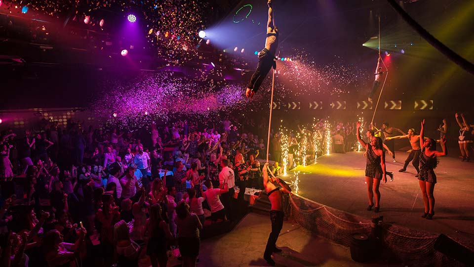 un grupo de personas en un escenario con una multitud mirando