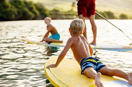 junge Familie beim Stand Up Paddling auf Mallorca