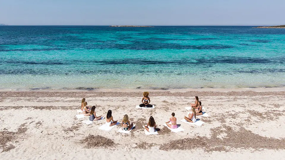 a group of women sitting on a beach