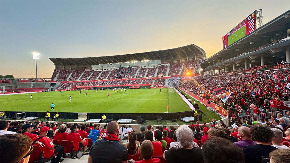 ein Fußballstadion mit einem Spielfeld und Spielern auf dem Spielfeld